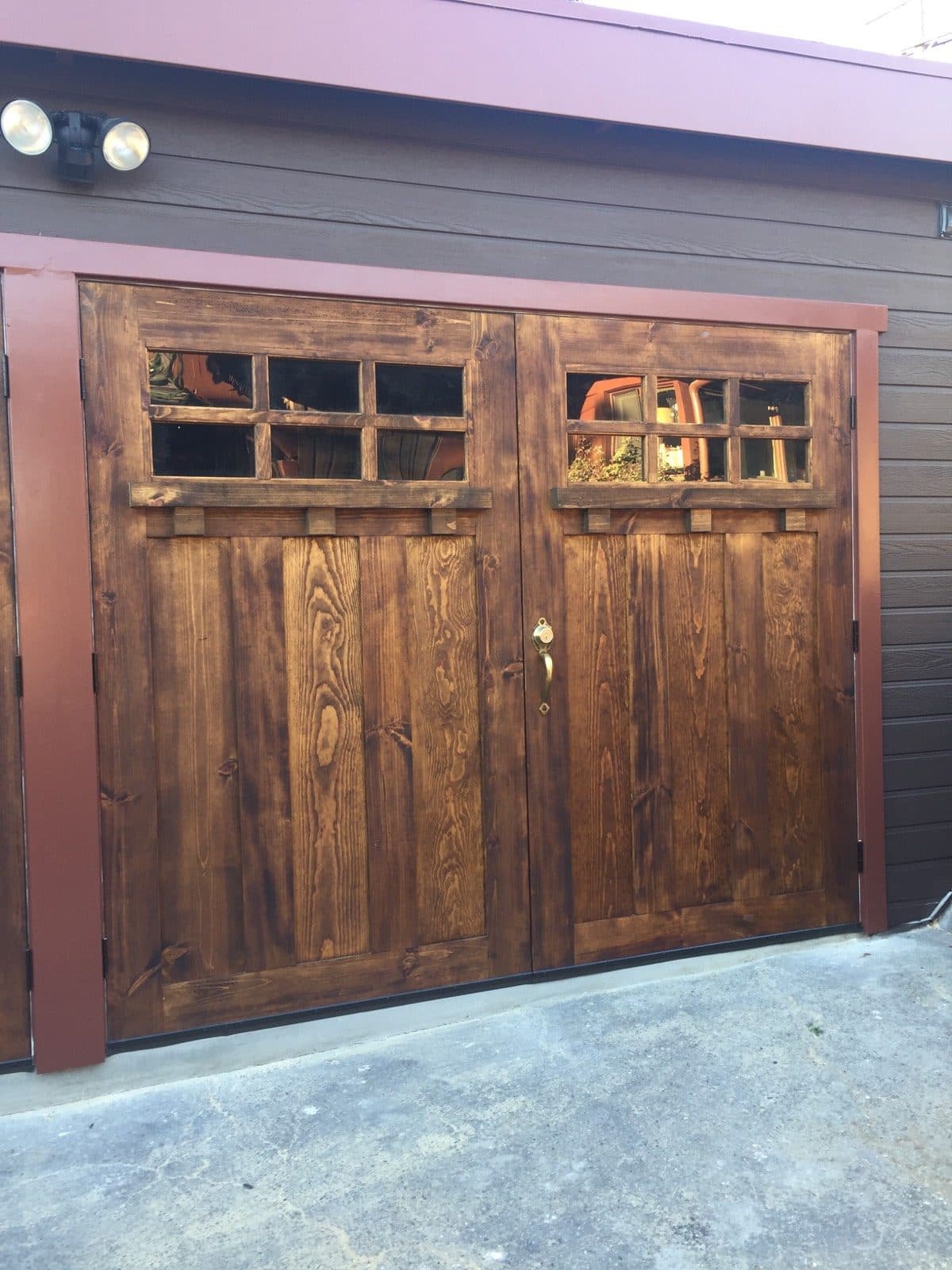 Hand-built wood garage door adding curb appeal to a two-story home